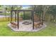 Outdoor firepit with swing seating and stone pavers at 22119 Weeks Blvd, Land O Lakes, FL 34639