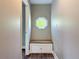 Cozy hallway featuring a window seat with storage and an octagonal window at 22119 Weeks Blvd, Land O Lakes, FL 34639