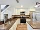 Beautiful kitchen boasting stainless steel appliances, granite countertops, and white cabinetry at 22119 Weeks Blvd, Land O Lakes, FL 34639