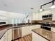Well-appointed kitchen featuring stainless steel appliances, granite countertops, and ample cabinet space at 22119 Weeks Blvd, Land O Lakes, FL 34639
