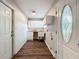 Functional laundry room with a utility sink, ample cabinetry, and exterior access at 22119 Weeks Blvd, Land O Lakes, FL 34639