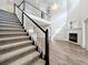 Spacious living room with high ceilings, fireplace, and staircase at 22119 Weeks Blvd, Land O Lakes, FL 34639