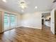 Cozy living room featuring wood floors and a sliding glass door offering backyard views at 22119 Weeks Blvd, Land O Lakes, FL 34639