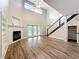 Bright living room featuring a soaring ceiling, fireplace, and access to the backyard patio at 22119 Weeks Blvd, Land O Lakes, FL 34639