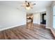 Bright living room with sleek wood floors, ceiling fan and easy access to the kitchen at 22119 Weeks Blvd, Land O Lakes, FL 34639