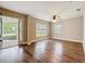 Bright living room with wood floors and large windows offering plenty of natural light at 22119 Weeks Blvd, Land O Lakes, FL 34639