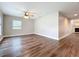 Spacious living room featuring wood floors, a ceiling fan, and plenty of natural light at 22119 Weeks Blvd, Land O Lakes, FL 34639