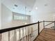 Loft area with railing overlooking the living space below at 22119 Weeks Blvd, Land O Lakes, FL 34639