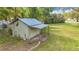 Exterior view of backyard shed with green paint and tin roof at 22119 Weeks Blvd, Land O Lakes, FL 34639