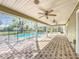 Spacious screened patio with brick floors, ceiling fans, and a pool view at 22119 Weeks Blvd, Land O Lakes, FL 34639