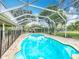 Screened pool area with brick patio and surrounding greenery at 22119 Weeks Blvd, Land O Lakes, FL 34639