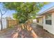 Brick patio in backyard shaded by a large tree and a wood fence at 230 Davison Ne Ave, St Petersburg, FL 33703