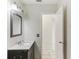 Updated bathroom with a mirror, vanity, toilet, and a doorway to another room at 230 Davison Ne Ave, St Petersburg, FL 33703