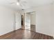 A bedroom with wood look floors, a closet, and access to the bathroom at 230 Davison Ne Ave, St Petersburg, FL 33703