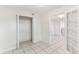 Bright bedroom space showcasing an open closet and an adjacent room through glass paneled doors at 230 Davison Ne Ave, St Petersburg, FL 33703