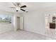 Bright bedroom featuring a ceiling fan, tile floors, and a sunny window view at 230 Davison Ne Ave, St Petersburg, FL 33703