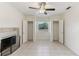 Large bedroom with a fireplace, tile floors, ceiling fan, and dual closets at 230 Davison Ne Ave, St Petersburg, FL 33703