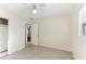 This bedroom features tile flooring, a ceiling fan, and a sliding closet at 230 Davison Ne Ave, St Petersburg, FL 33703