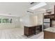 Spacious kitchen with a kitchen island, granite countertops, stainless steel appliances, and tiled flooring at 230 Davison Ne Ave, St Petersburg, FL 33703