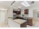 Open-concept kitchen features granite countertops, stainless steel appliances, and a bright skylight at 230 Davison Ne Ave, St Petersburg, FL 33703
