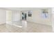 Spacious, tiled living area with sliding glass doors, windows, and easy access to the outdoors at 230 Davison Ne Ave, St Petersburg, FL 33703
