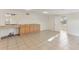 Open living space with tile flooring and a counter to the kitchen at 230 Davison Ne Ave, St Petersburg, FL 33703