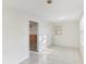 Open living room with tile floors, natural light, and a doorway to the kitchen at 230 Davison Ne Ave, St Petersburg, FL 33703