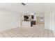 Open-concept living space connecting kitchen with granite counters and modern appliances at 230 Davison Ne Ave, St Petersburg, FL 33703
