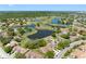 Community aerial shot featuring lush landscapes and serene lakes amidst homes in a friendly neighborhood at 2618 Newcomb Ct # 12, Sun City Center, FL 33573