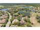An aerial view of residential homes with beautiful water views and lush green landscaping at 2618 Newcomb Ct # 12, Sun City Center, FL 33573