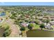 An aerial view of residential homes with beautiful water views and lush green landscaping at 2618 Newcomb Ct # 12, Sun City Center, FL 33573