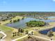 An aerial view of a golf course, residential homes and a beautiful scenic lake at 2618 Newcomb Ct # 12, Sun City Center, FL 33573