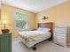 Bedroom featuring a large window, carpet, and wooden furniture at 2618 Newcomb Ct # 12, Sun City Center, FL 33573