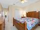Cozy bedroom features a ceiling fan, wood furniture, and a colorful quilt at 2618 Newcomb Ct # 12, Sun City Center, FL 33573