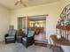 Covered lanai with seating, offering a view into the bright and open living space at 2618 Newcomb Ct # 12, Sun City Center, FL 33573