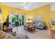 Inviting living room with tile floors, sliding glass doors to the lanai, and cozy furniture at 2618 Newcomb Ct # 12, Sun City Center, FL 33573