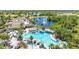Picture of the community pool surrounded by palm trees and lounge chairs near a serene lake at 2618 Newcomb Ct # 12, Sun City Center, FL 33573