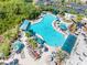 Aerial view of a large, resort-style pool with ample seating and umbrella-shaded areas at 2618 Newcomb Ct # 12, Sun City Center, FL 33573