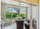 Screened porch with views of the well-maintained landscaping and exterior of the home at 2618 Newcomb Ct # 12, Sun City Center, FL 33573