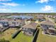 Aerial view showcasing a community with lake access and screened lanais, ideal for outdoor living at 2934 Living Coral Dr, Odessa, FL 33556