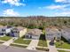 Aerial view of a suburban street featuring various home styles and manicured lawns on a sunny day at 2934 Living Coral Dr, Odessa, FL 33556