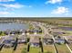 Panoramic aerial shot of homes in a Primary-planned community situated around a lake and green spaces at 2934 Living Coral Dr, Odessa, FL 33556