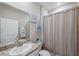 Bathroom featuring stylish vanity and tub with shower at 2934 Living Coral Dr, Odessa, FL 33556