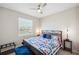 Bedroom features natural light, soft carpet, and nautical-themed comforter at 2934 Living Coral Dr, Odessa, FL 33556