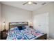 Cozy bedroom features stylish furniture, a ceiling fan, and a bright comforter at 2934 Living Coral Dr, Odessa, FL 33556