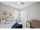 Comfortable bedroom with a ceiling fan, natural light, a cozy bed and a work space at 2934 Living Coral Dr, Odessa, FL 33556