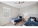 Bedroom includes two twin beds, soft carpet, and modern ceiling fan at 2934 Living Coral Dr, Odessa, FL 33556