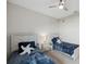 Bedroom includes two twin beds, soft carpet, and modern ceiling fan at 2934 Living Coral Dr, Odessa, FL 33556