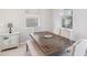 Cozy dining area features a modern light fixture, windows, and a rustic wood table at 2934 Living Coral Dr, Odessa, FL 33556
