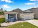 Charming single-story home featuring stone accents, a two-car garage, and a welcoming front porch at 2934 Living Coral Dr, Odessa, FL 33556